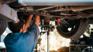 Mechanic working underneath vehicle.