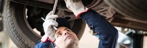 Mechanic working underneath vehicle.