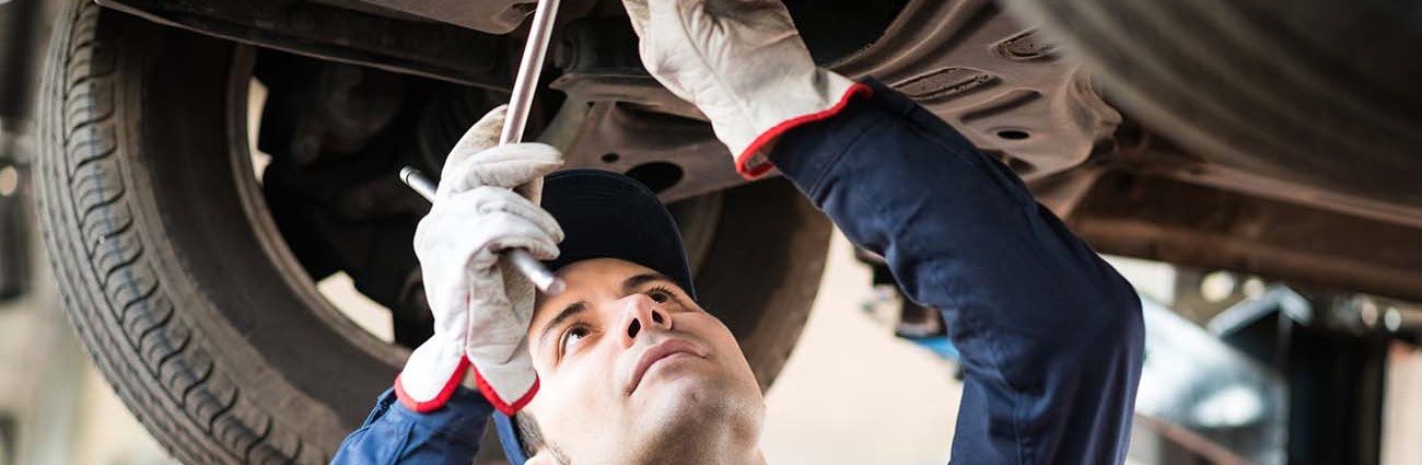 Mechanic working underneath vehicle.