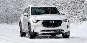 Mazda vehicle driving in the snow.