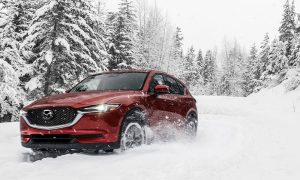 Mazda vehicle driving through snow